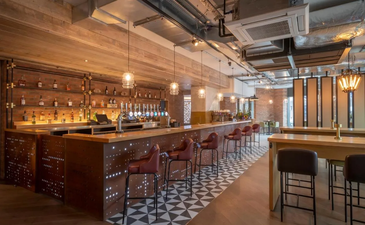 Bar area with chairs and tables at Maldron Hotel Finsbury Park, London