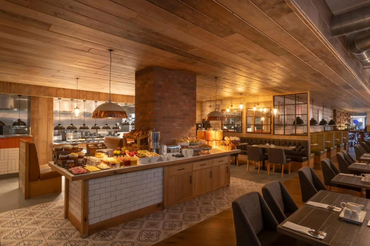 Restaurant buffet with tables and chairs at Maldron Hotel Finsbury Park, London