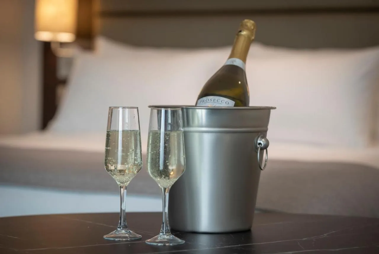 A bottle of champagne in a bucket with two glasses at Maldron Hotel Finsbury Park, London